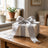 Elegant wrapped gift box with silver ribbon on a wooden table