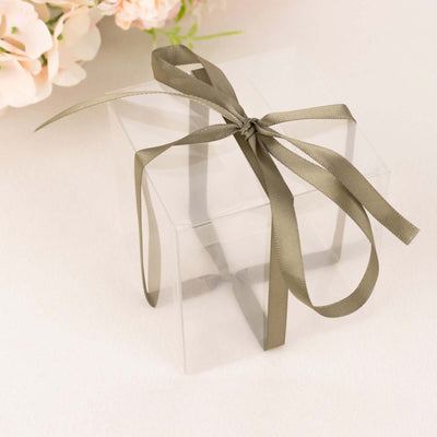 Clear gift box with a stylish olive green ribbon tied in a bow.