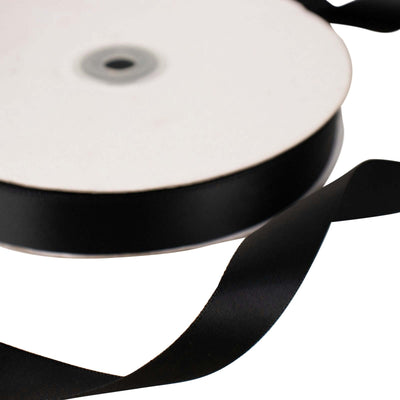 Black satin ribbon on a roll with a smooth finish.