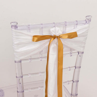 Clear chair with white and gold satin ribbon bow on the back
