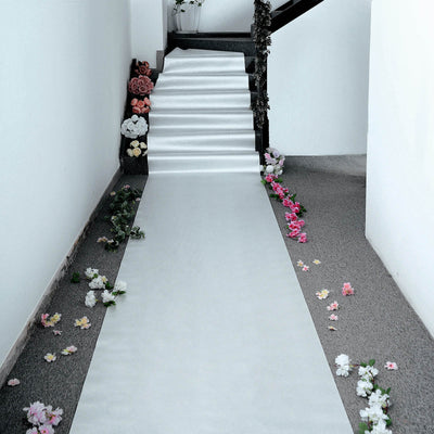 Elegant white carpet runner adorned with flowers, perfect for events or ceremonies.