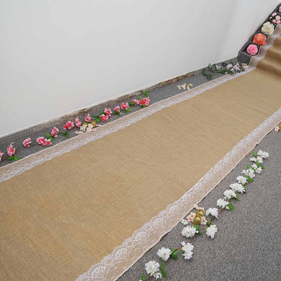 Burlap wedding aisle runner with lace trim and floral decorations