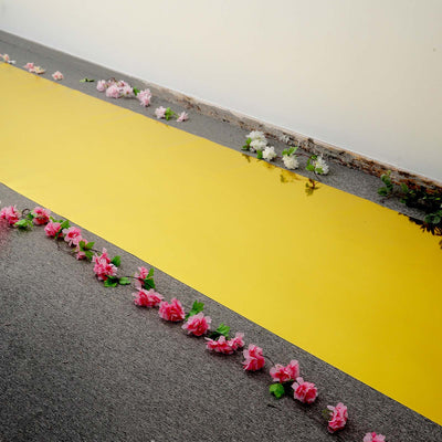 Yellow runner with pink and white floral decorations along the edges.