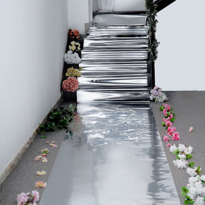 Shiny silver staircase decor with floral accents on the sides.