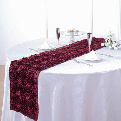 Burgundy rose-patterned table runner on a round dining table.