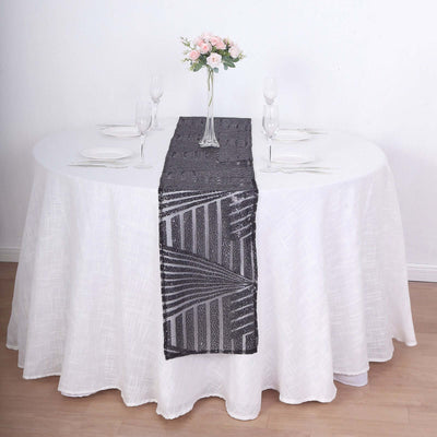 Decorative gray table runner on a round dining table with floral centerpiece.