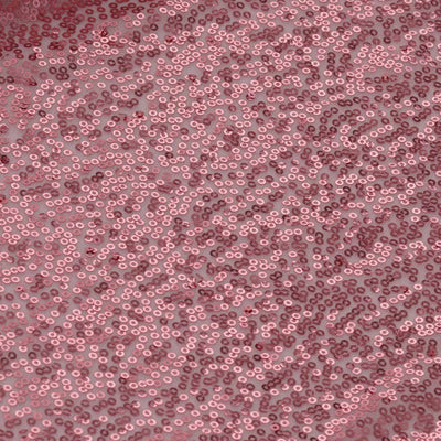 Pink sequin fabric texture in a shimmering pattern.