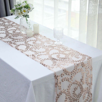 Elegant table runner with floral design on a white tablecloth.