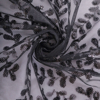 Black sequined lace fabric with floral pattern detail.