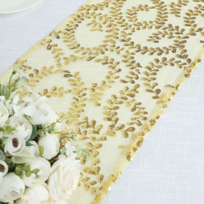 Gold sequin table runner with floral design on a light fabric background.