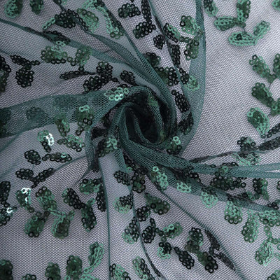 Green sequined tulle fabric with floral pattern detail.