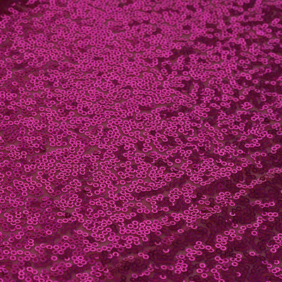 Fuchsia sequined fabric with a shimmering texture.