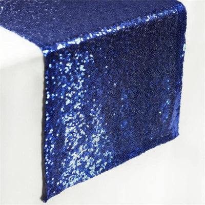 Navy blue sequin table runner draping over a table edge.