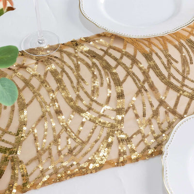Gold sequin table runner with intricate wave pattern on a white table setting.