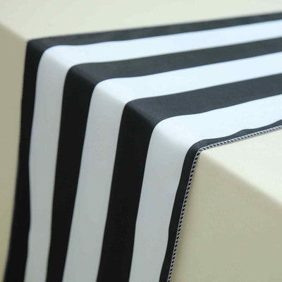 Black and white striped table runner on a neutral surface.