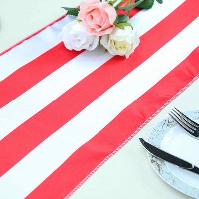 Red and white striped table runner with artificial flowers