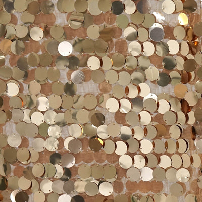 Gold sequin fabric texture for fashion and craft projects.