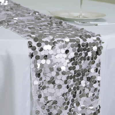 Silver sequin table runner draped on a white table.