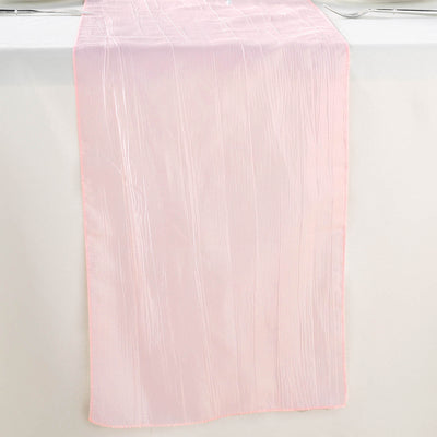 Pink sheer table runner with textured finish on a plain backdrop