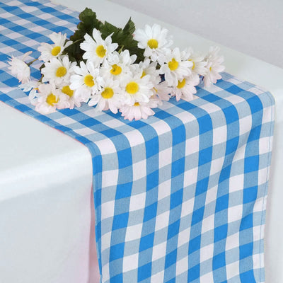Blue checkered table runner with white daisies on a white table