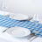 Blue checkered tablecloth dining table setting with white plates and wine glasses