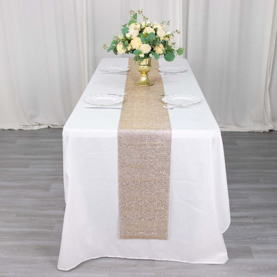 Elegant table setting with a floral centerpiece and burlap runner.