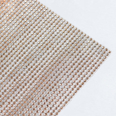 Shimmering rhinestone fabric sheet with a sparkling design.
