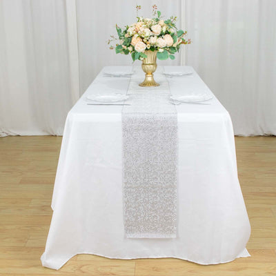 Elegant table setting with a floral centerpiece and decorative table runner.