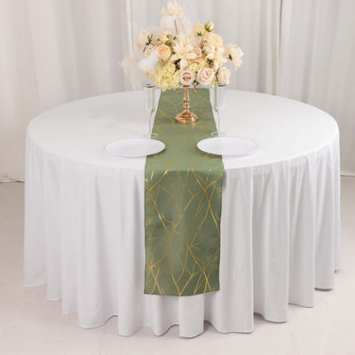 Elegant green table runner with gold accents on a round white table.
