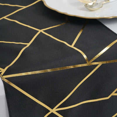 Black table runner with gold geometric lines design.