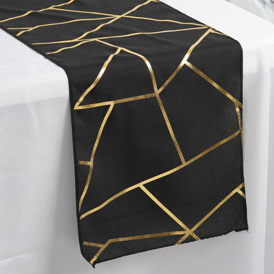 Black table runner with gold geometric design.