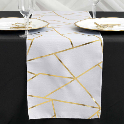 Gold geometric pattern table runner on a black table setting.