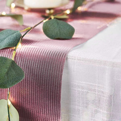 Elegant pink table runner with textured stripes and greenery accents.