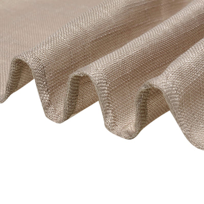 Close-up of textured beige fabric showcasing its woven pattern and soft drape.