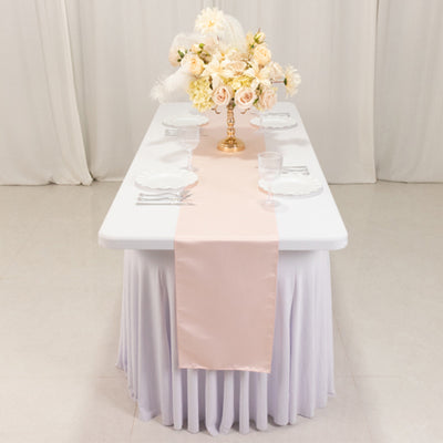 Elegant table setting with pink runner and floral centerpiece.