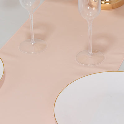 Elegant pink table runner with gold-accented dinnerware and glassware.