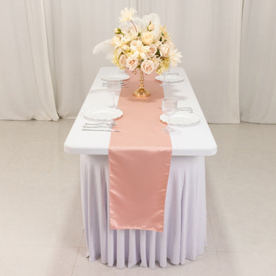 Elegant table setting with a pink runner and floral centerpiece.