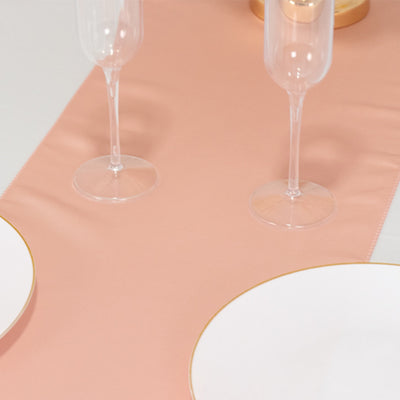 Elegant pink table runner with gold-accented dinnerware and glasses.