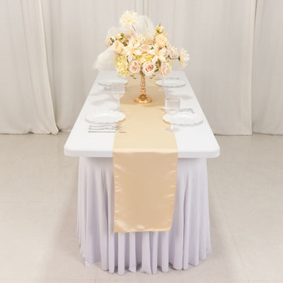 Elegant table setting with floral centerpiece and satin table runner.