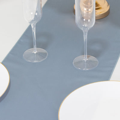 Elegant blue table runner with gold-accented plates and champagne flutes.
