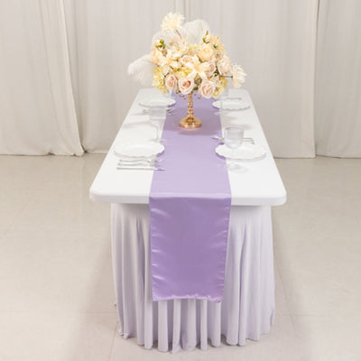 Purple table runner on a banquet table with floral centerpiece.