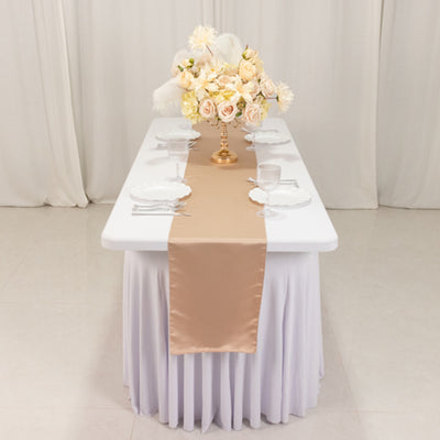 Elegant table setting with floral centerpiece and satin runner.