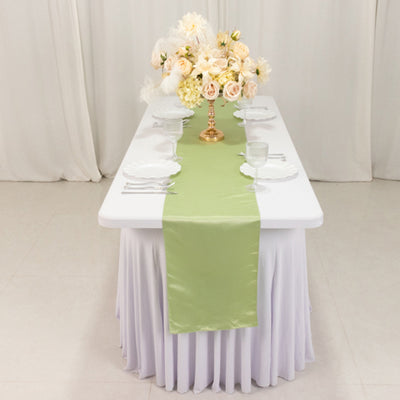 Green table runner on a dining table with floral centerpiece and elegant place settings.