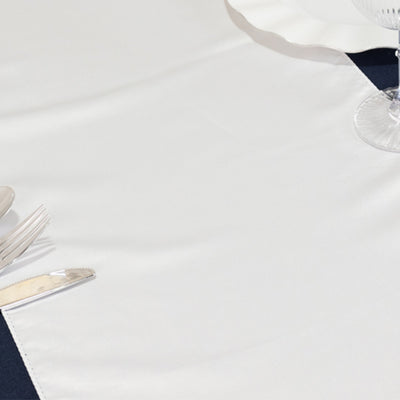 Elegant white table runner on a dark table setting
