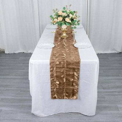 Elegant brown table runner on a dressed dining table with floral centerpiece.