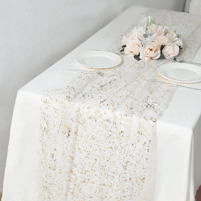 Elegant gold and white table runner on a dining table with floral centerpiece.