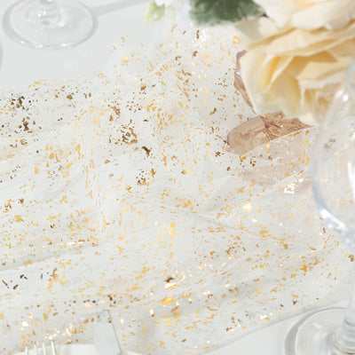 Elegant white fabric with gold flecks, perfect for table decor.
