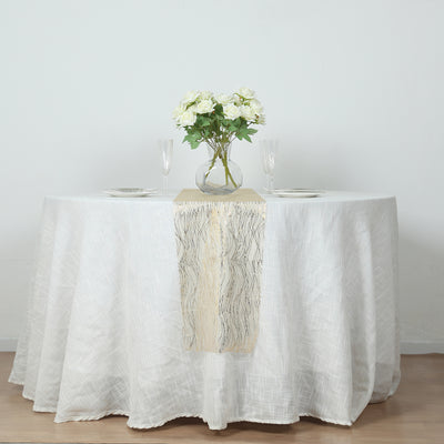 Elegant round dining table set with floral centerpiece and table runner.