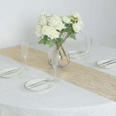 Elegant table setting with roses, glassware, and plates.