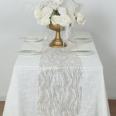 Elegant table setting with floral centerpiece and gold-accented table runner.